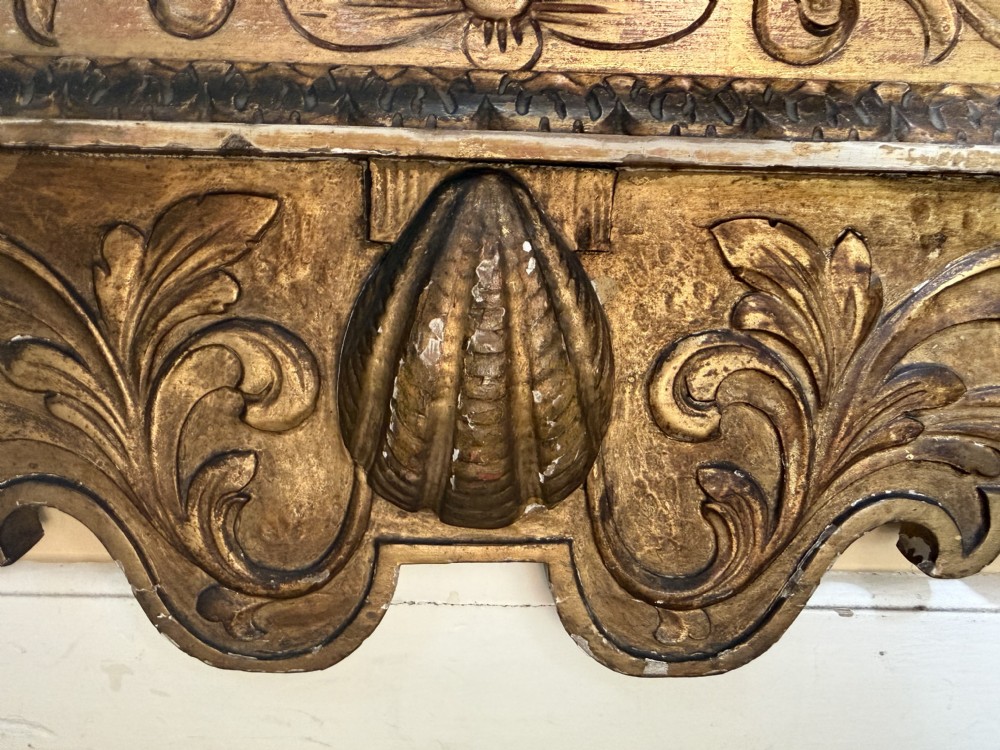 Mid 19th-century George II style carved giltwood pier mirror featuring a swan-neck pediment and carved shell apron. View XIII
