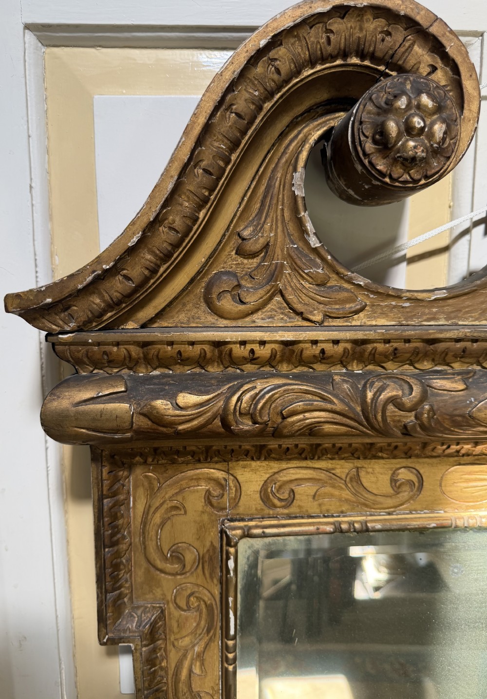 Mid 19th-century George II style carved giltwood pier mirror featuring a swan-neck pediment and carved shell apron. View VI