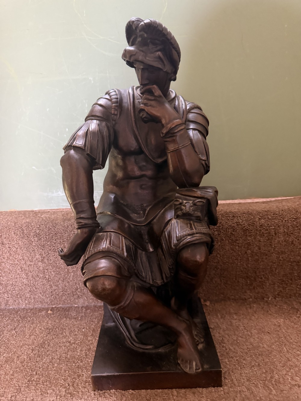 A pair of patinated dark bronze sculptures depicting two seated male figures in classical Roman armour mounted on rectangular bases. View VIII