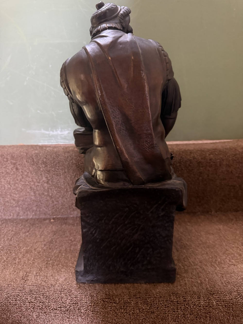 A pair of patinated dark bronze sculptures depicting two seated male figures in classical Roman armour mounted on rectangular bases. View X