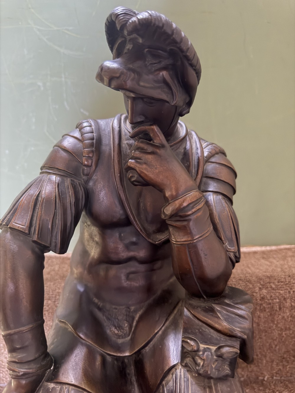 A pair of patinated dark bronze sculptures depicting two seated male figures in classical Roman armour mounted on rectangular bases. View XII