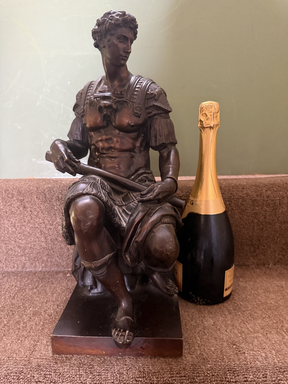 A pair of patinated dark bronze sculptures depicting two seated male figures in classical Roman armour mounted on rectangular bases. View XV