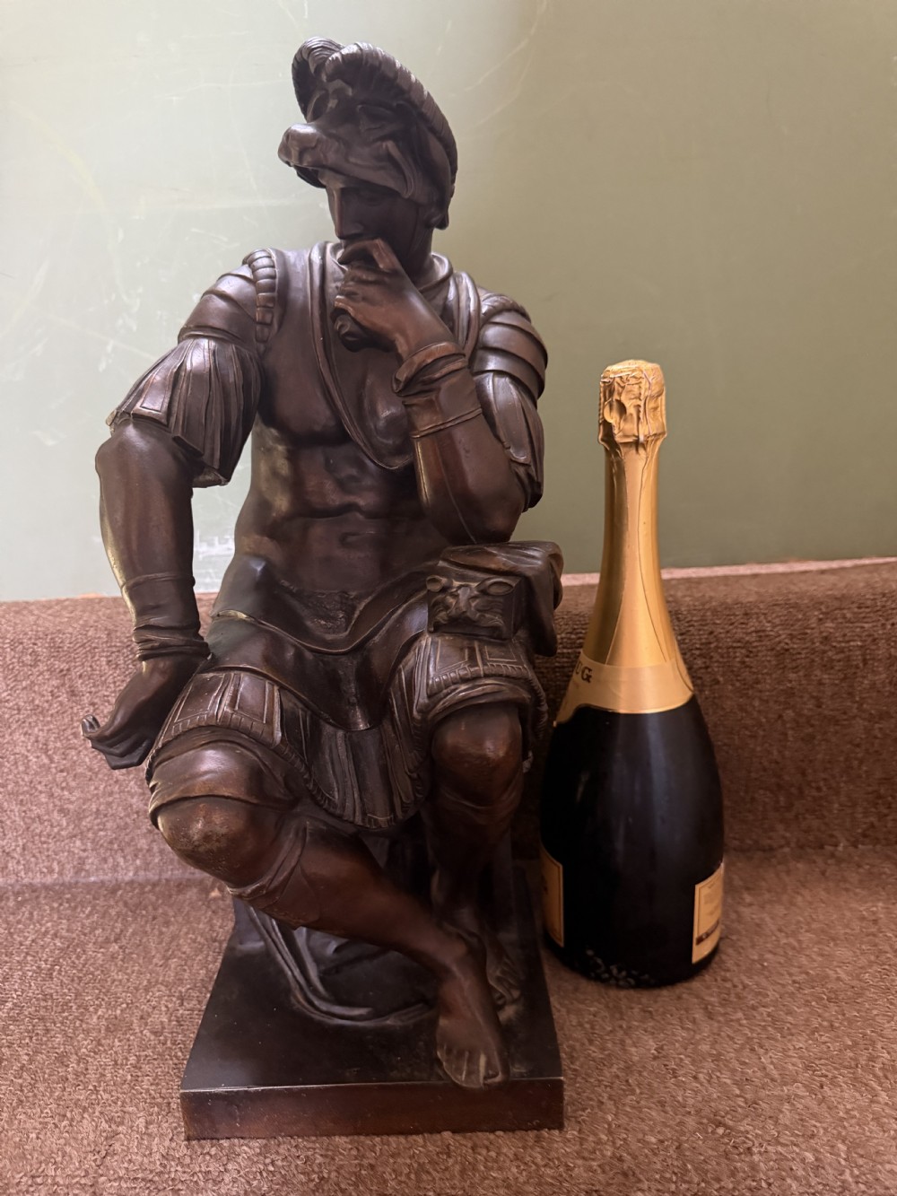 A pair of patinated dark bronze sculptures depicting two seated male figures in classical Roman armour mounted on rectangular bases. View XVI