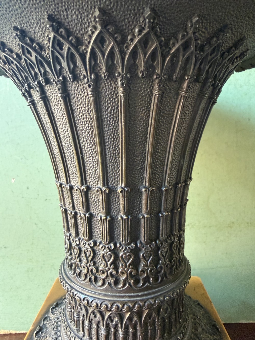 A pair of early nineteenth-century French bronze flared urns with Gothic tracery detailing, set upon square yellow Siena marble plinth bases with bronze bracket feet. View IX