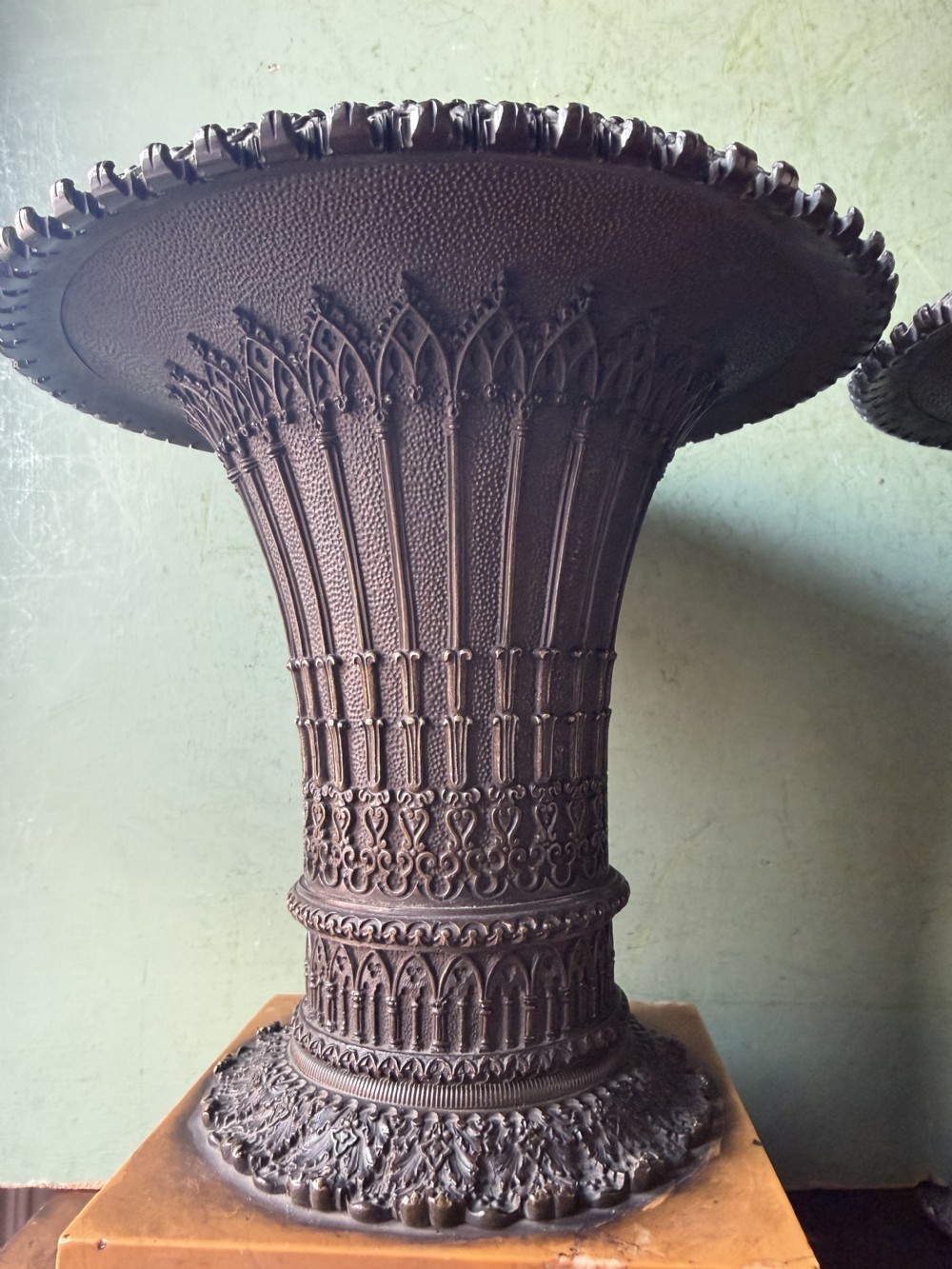 A pair of early nineteenth-century French bronze flared urns with Gothic tracery detailing, set upon square yellow Siena marble plinth bases with bronze bracket feet. View XVIII