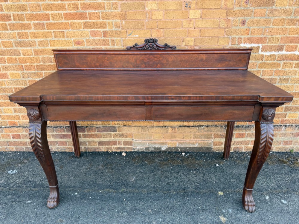A large early 19th-century George IV mahogany serving table featuring a raised gallery back with carved cresting, carved cabriole front legs, and lion paw feet. View III
