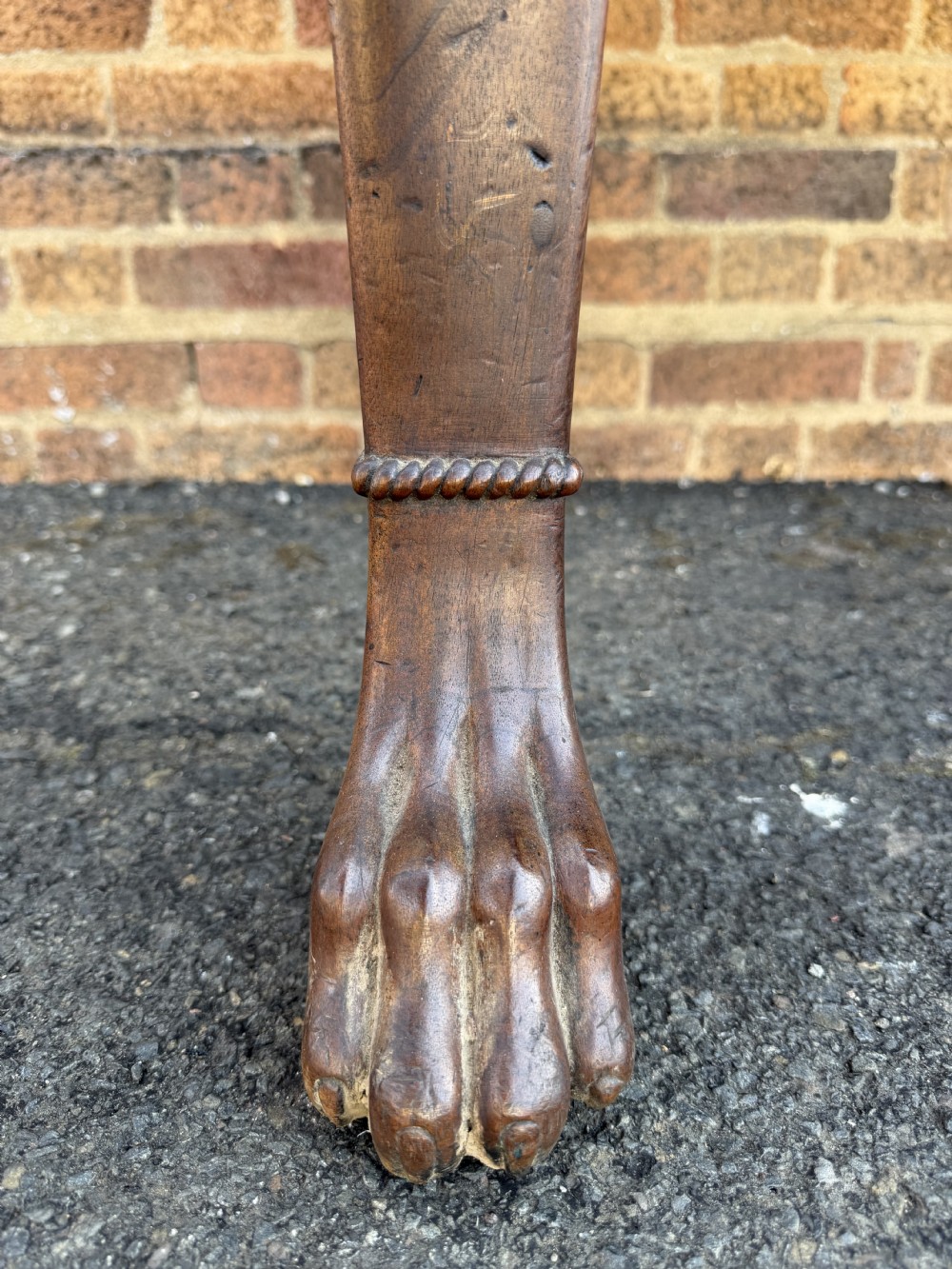 A large early 19th-century George IV mahogany serving table featuring a raised gallery back with carved cresting, carved cabriole front legs, and lion paw feet. View VII