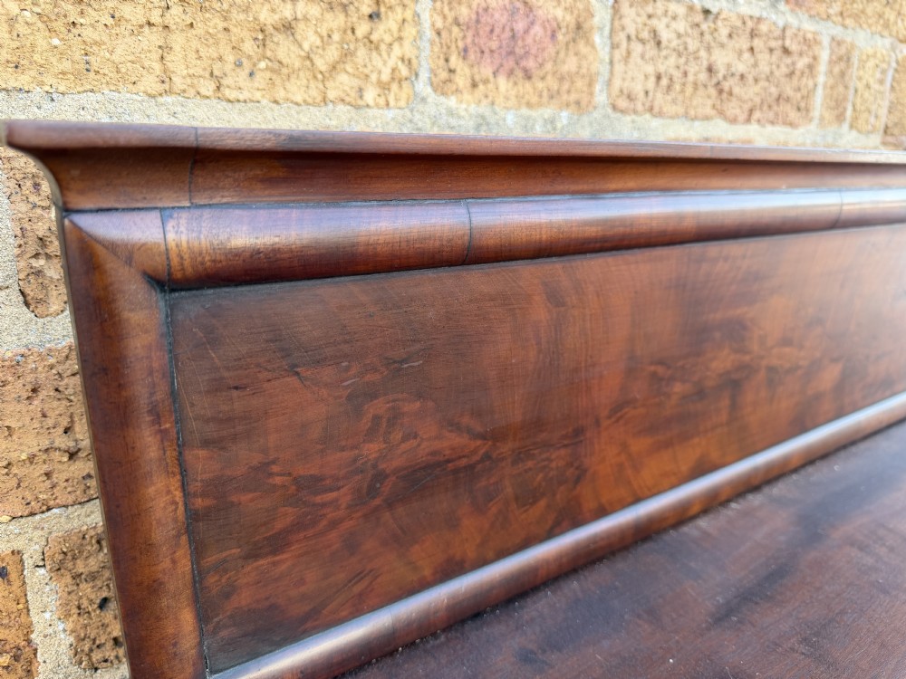 A large early 19th-century George IV mahogany serving table featuring a raised gallery back with carved cresting, carved cabriole front legs, and lion paw feet. View XVI