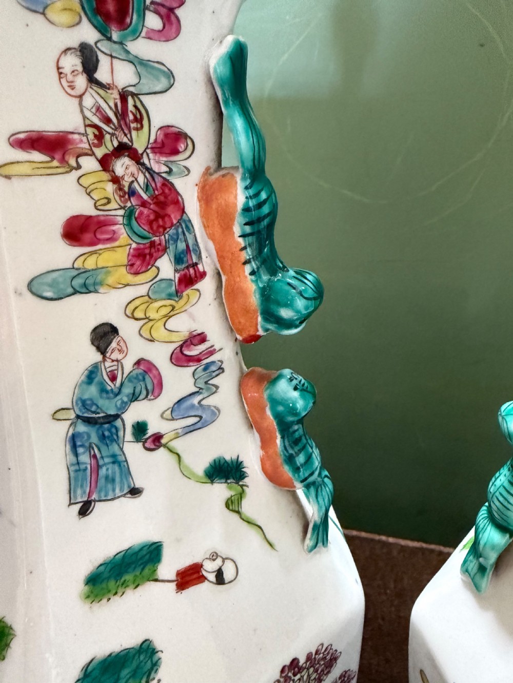 A pair of hexagonal Chinese famille-verte porcelain lamps decorated with figures in traditional scenes and set on gilded bases. View XIII