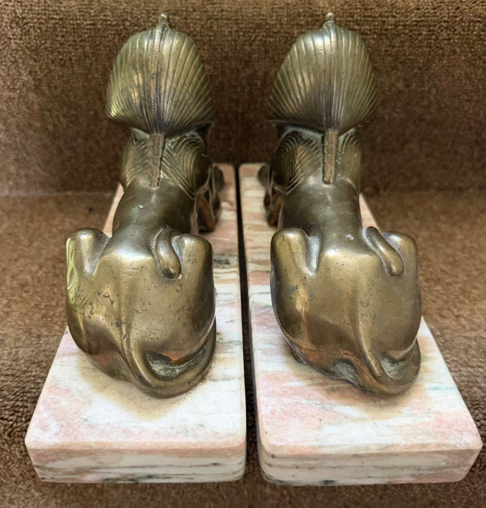 A pair of bronze recumbent sphinx sculptures featuring detailed Nemes headdresses mounted on rectangular pink marble bases. View XV