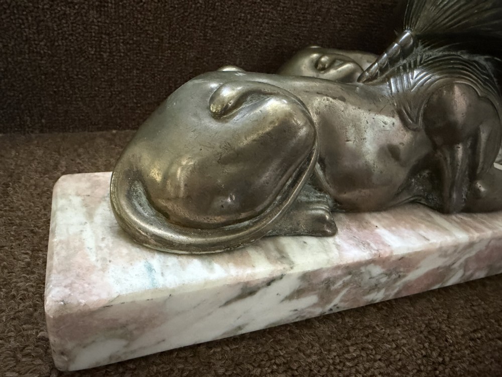 A pair of bronze recumbent sphinx sculptures featuring detailed Nemes headdresses mounted on rectangular pink marble bases. View XVII
