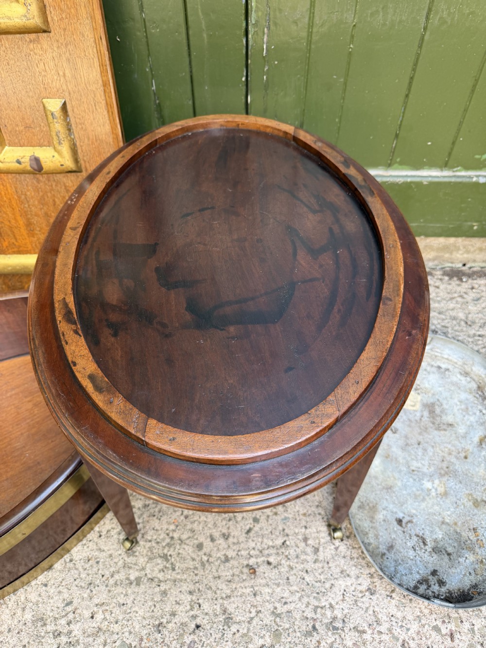 An 18th-century George III mahogany oval wine cooler with thick brass bands and brass handles, resting on a four-legged tapered stand with castors. View VIII