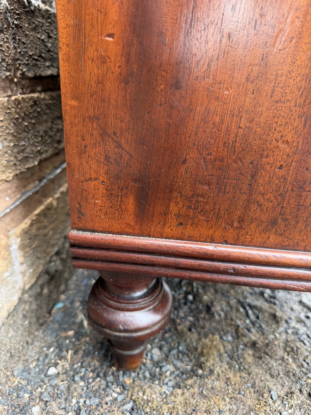 An early nineteenth-century George III mahogany low bookcase featuring two top frieze drawers over glazed twin doors and turned feet. View VIII