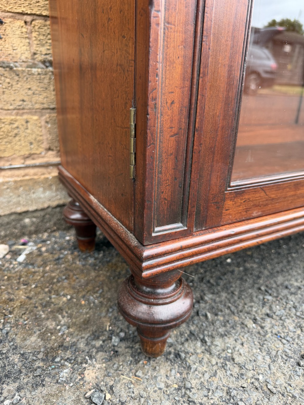 An early nineteenth-century George III mahogany low bookcase featuring two top frieze drawers over glazed twin doors and turned feet. View XXII