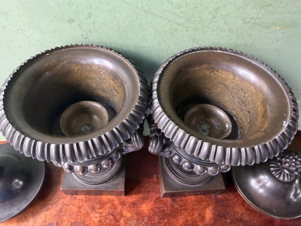A pair of Regency patinated bronze campana-shaped cassolettes with gadrooned bodies, twin handles, pinecone finials, and square bases. View VIII