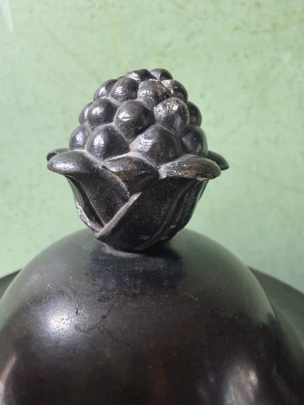 A pair of Regency patinated bronze campana-shaped cassolettes with gadrooned bodies, twin handles, pinecone finials, and square bases. View XI