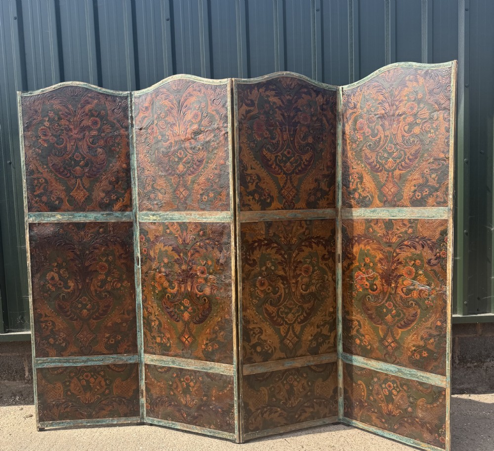 A late nineteenth-century four-fold canvas room screen featuring polychrome floral and scroll decoration in warm brown and green tones with serpentine cresting. View II