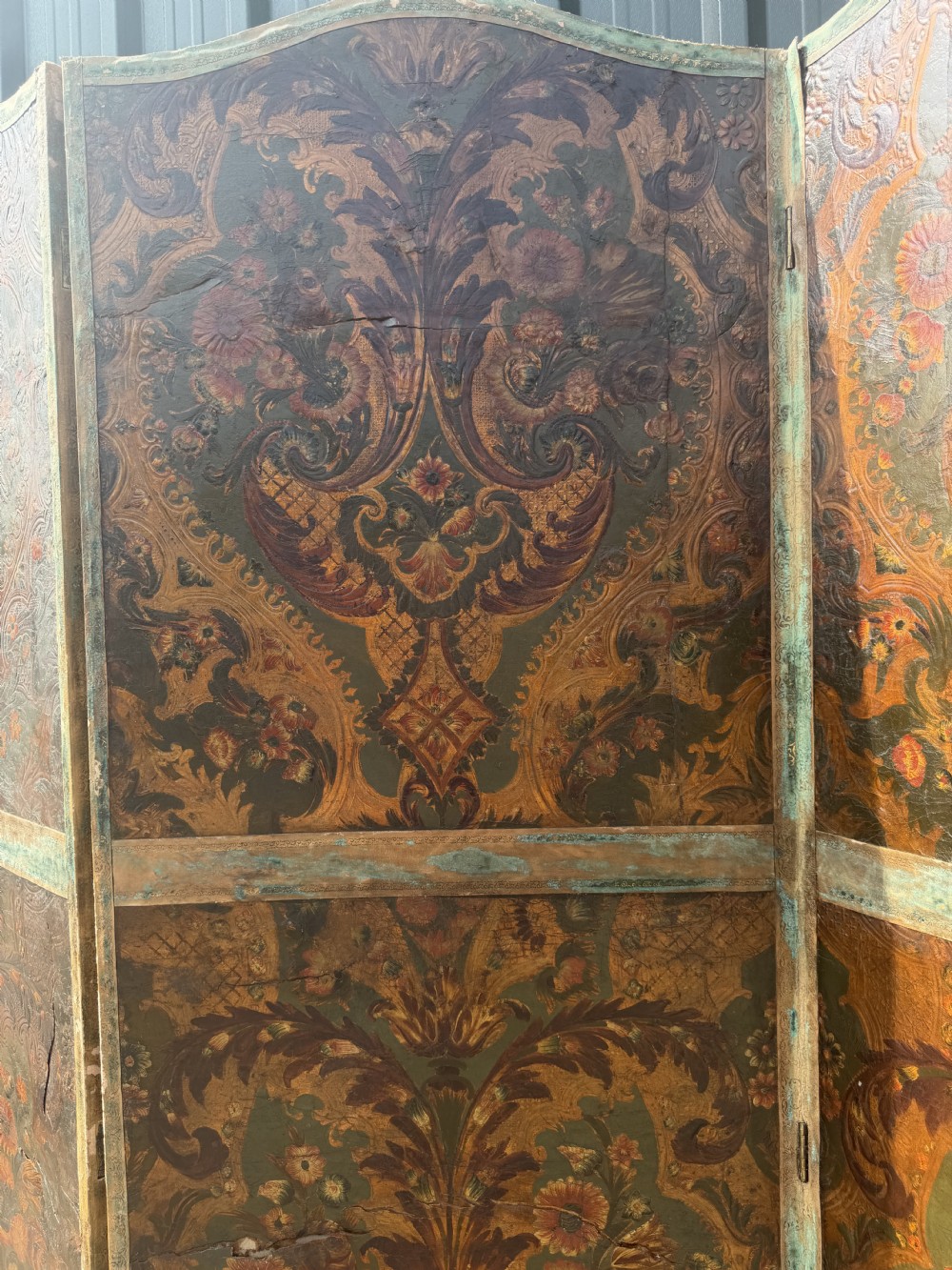 A late nineteenth-century four-fold canvas room screen featuring polychrome floral and scroll decoration in warm brown and green tones with serpentine cresting. View IV
