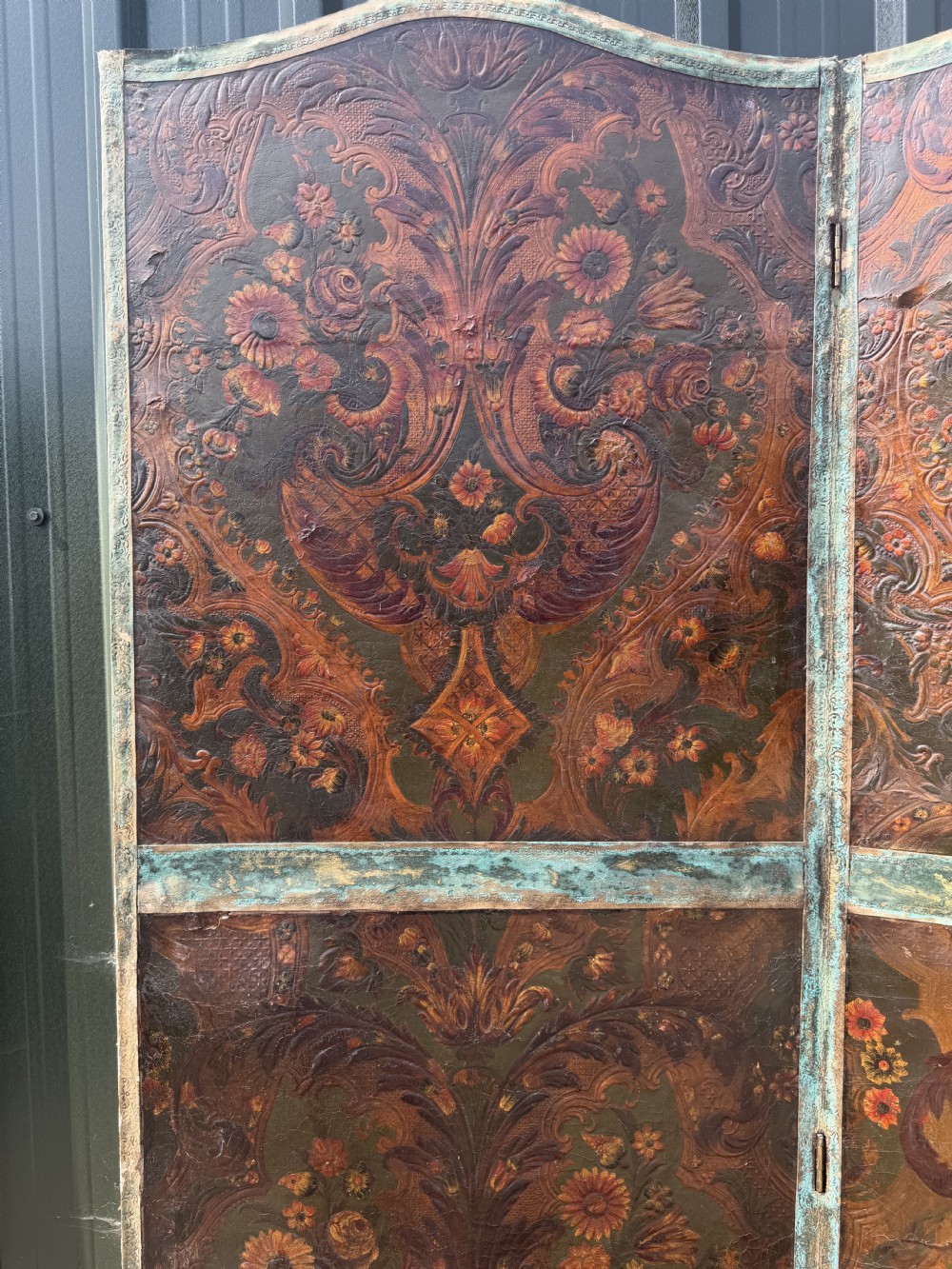A late nineteenth-century four-fold canvas room screen featuring polychrome floral and scroll decoration in warm brown and green tones with serpentine cresting. View VII