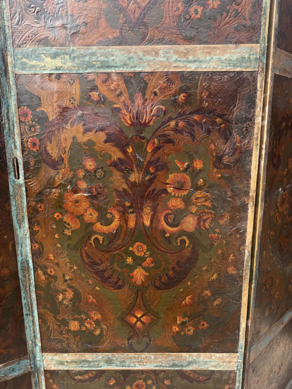 A late nineteenth-century four-fold canvas room screen featuring polychrome floral and scroll decoration in warm brown and green tones with serpentine cresting. View VIII