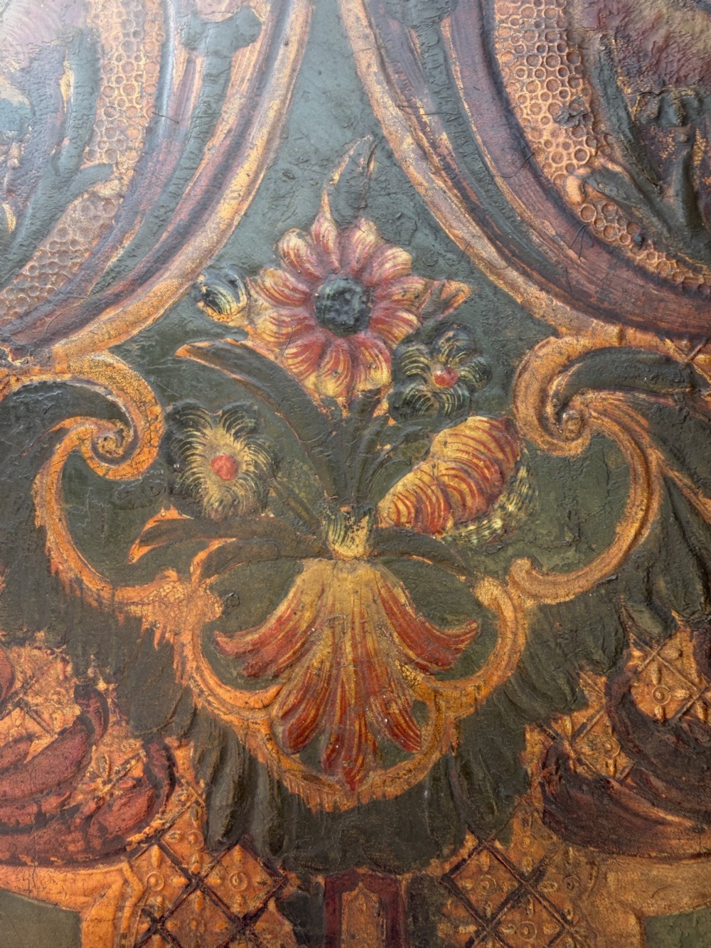A late nineteenth-century four-fold canvas room screen featuring polychrome floral and scroll decoration in warm brown and green tones with serpentine cresting. View XIV