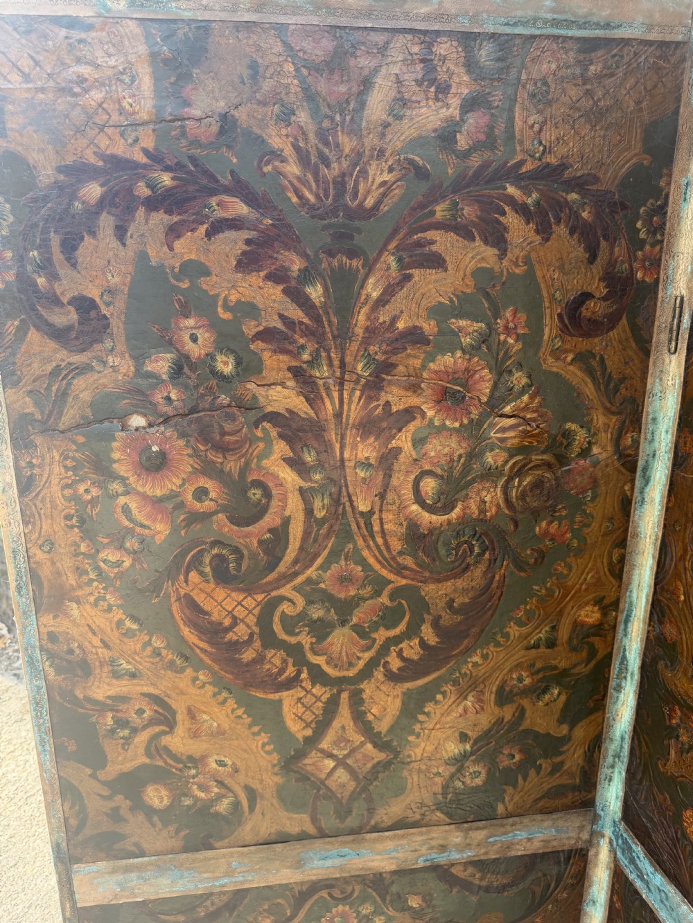 A late nineteenth-century four-fold canvas room screen featuring polychrome floral and scroll decoration in warm brown and green tones with serpentine cresting. View XV
