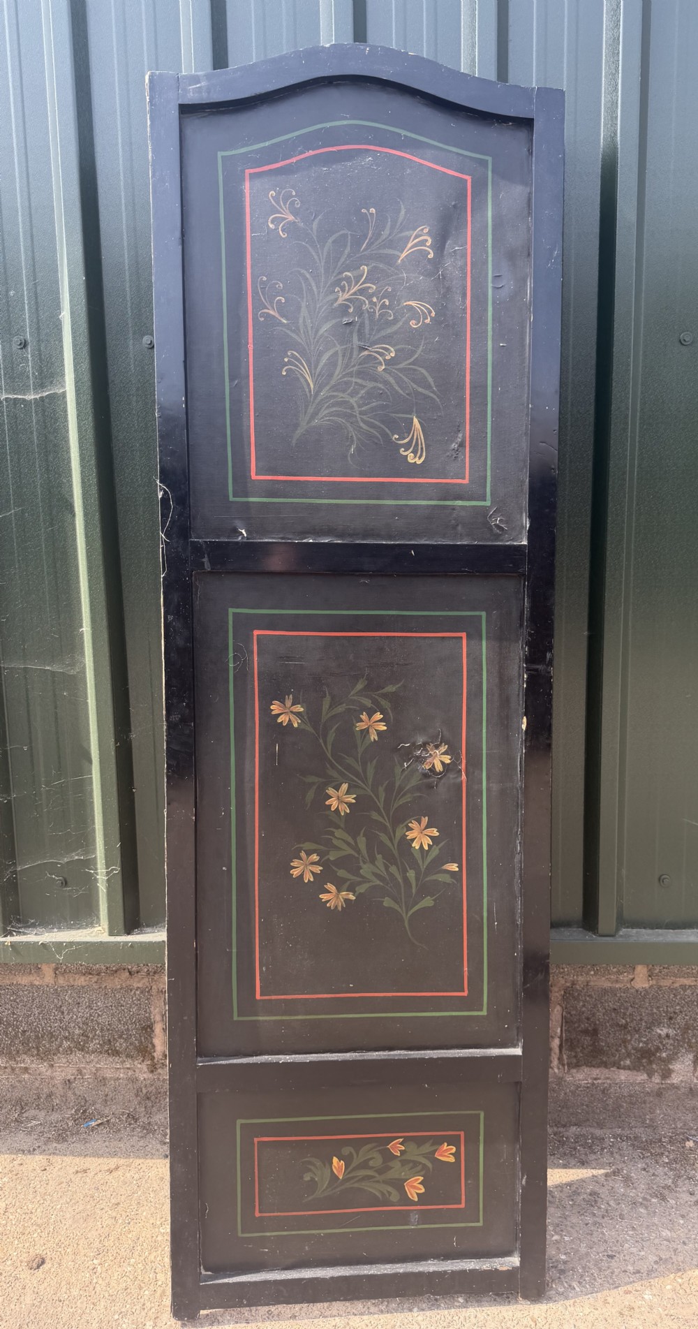 A late nineteenth-century four-fold canvas room screen featuring polychrome floral and scroll decoration in warm brown and green tones with serpentine cresting. View XIX