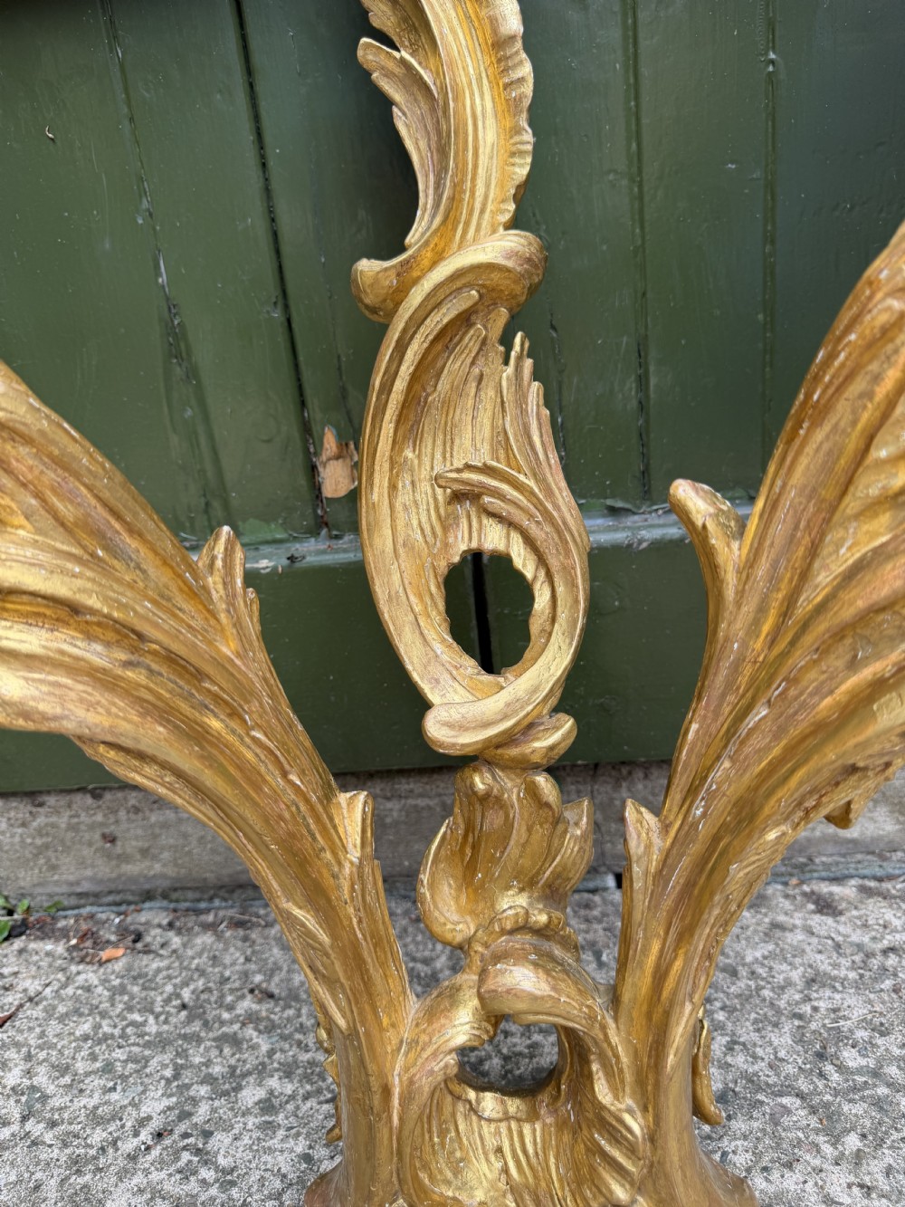 An 18th-century style French carved giltwood wall console table featuring intricate foliage, a central bird motif, and a variegated pink and ochre Breche dAlep marble top. View XXI