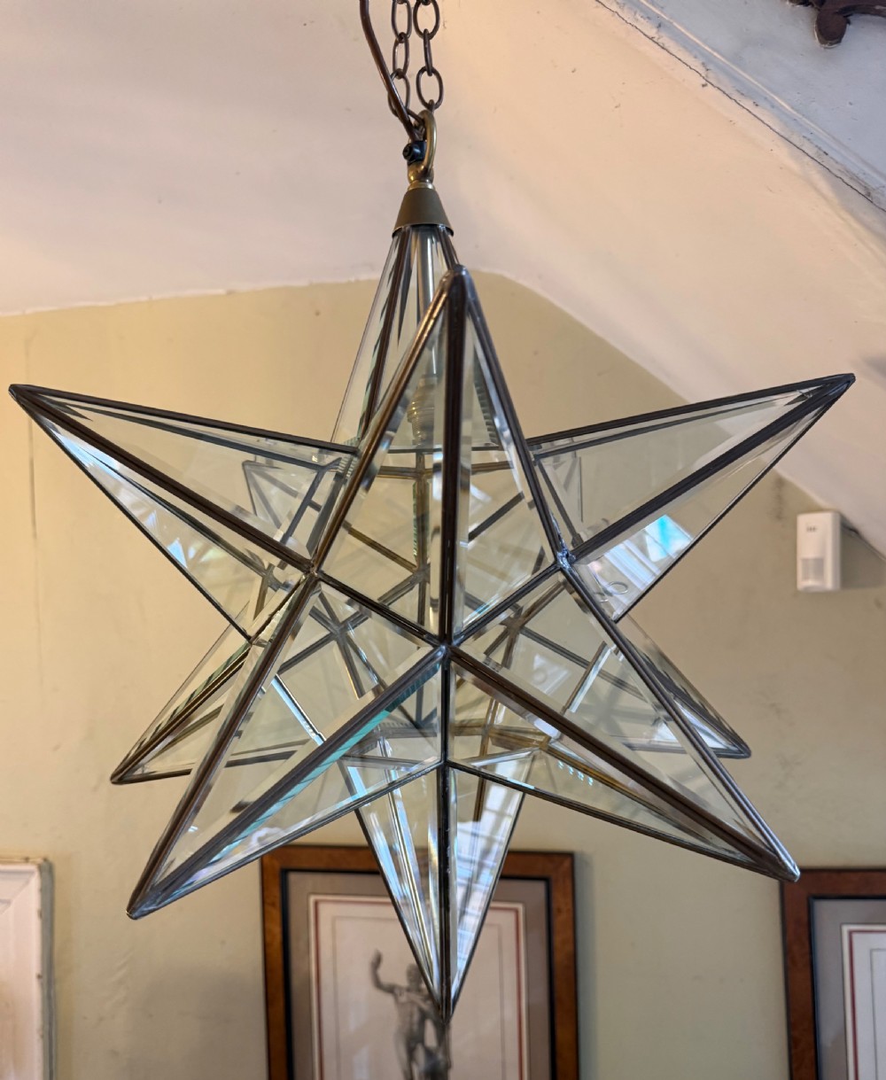 Striking early C20th 12-point brass-framed bevelled glass “Moravian” star hanging lantern.