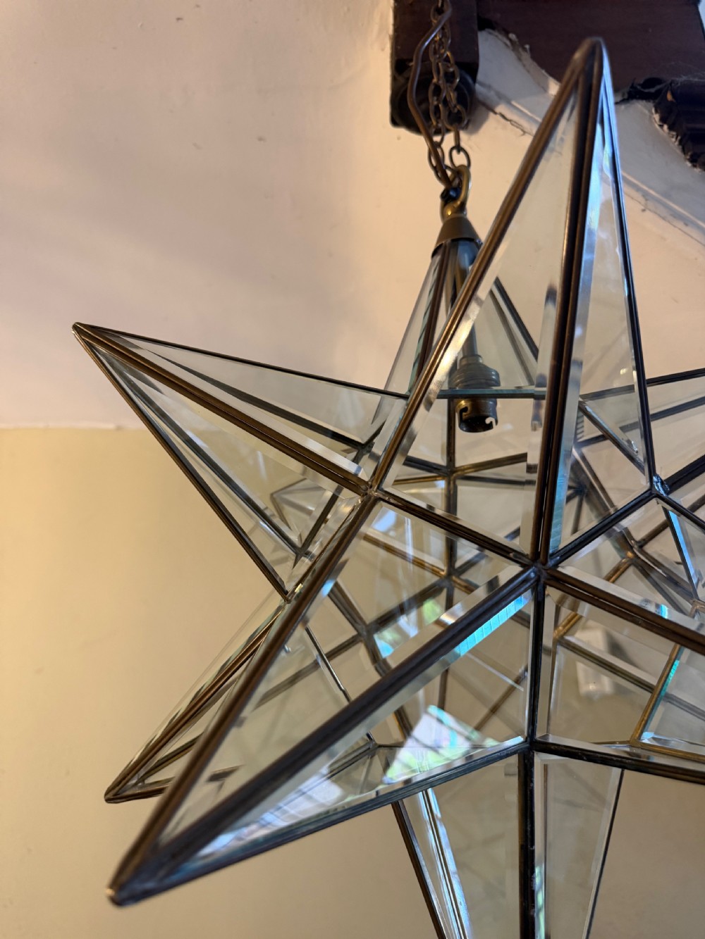 An early twentieth-century twelve-point Moravian star pendant lantern featuring a brass frame with clear bevelled glass panels and a chain drop. View VII