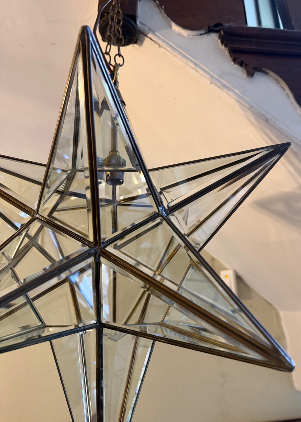 An early twentieth-century twelve-point Moravian star pendant lantern featuring a brass frame with clear bevelled glass panels and a chain drop. View VIII