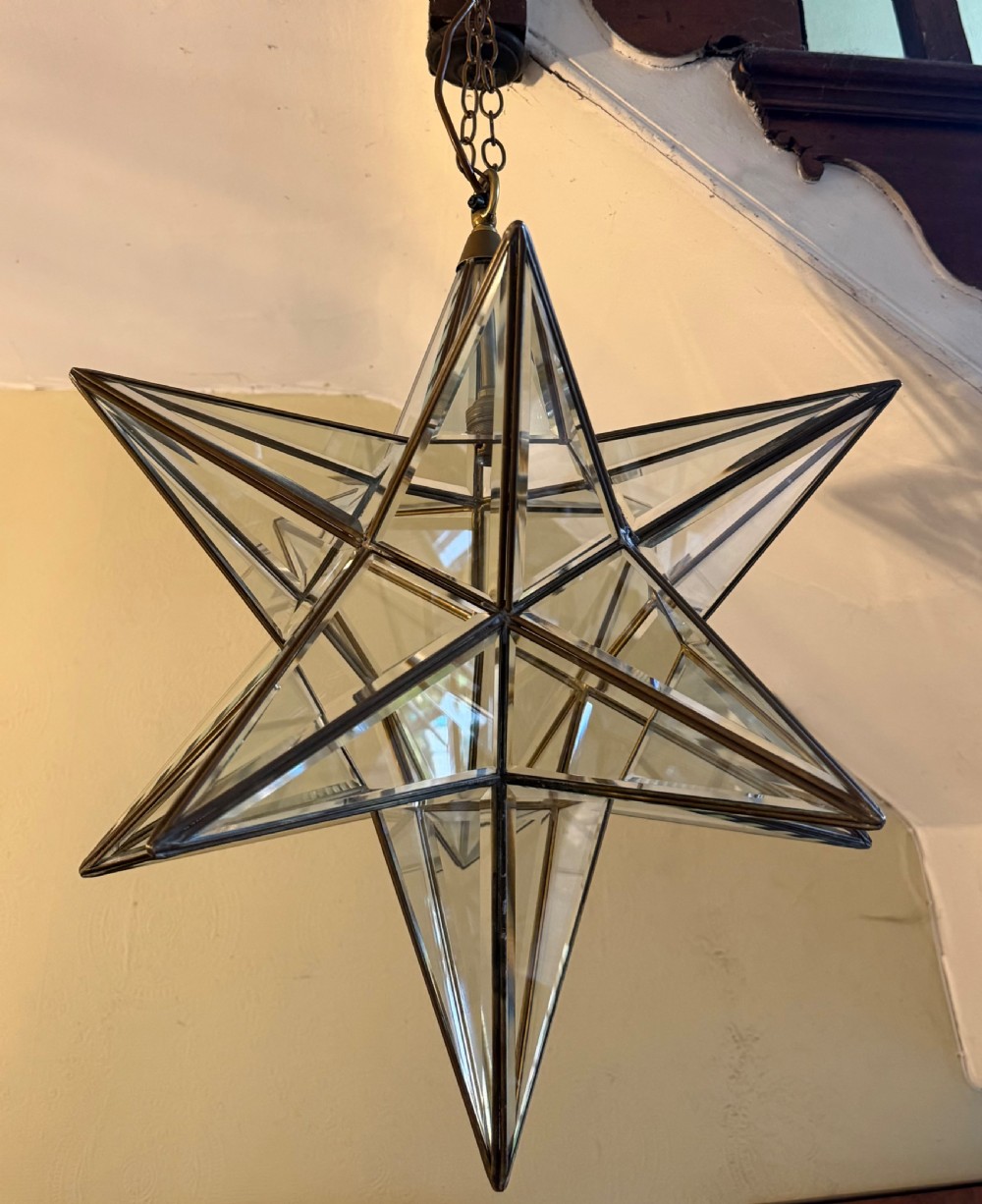 An early twentieth-century twelve-point Moravian star pendant lantern featuring a brass frame with clear bevelled glass panels and a chain drop. View IX