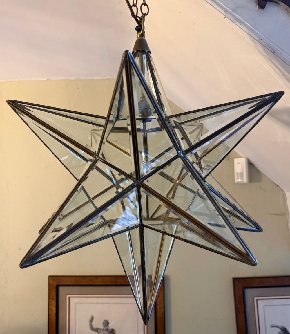 An early twentieth-century twelve-point Moravian star pendant lantern featuring a brass frame with clear bevelled glass panels and a chain drop. View XI