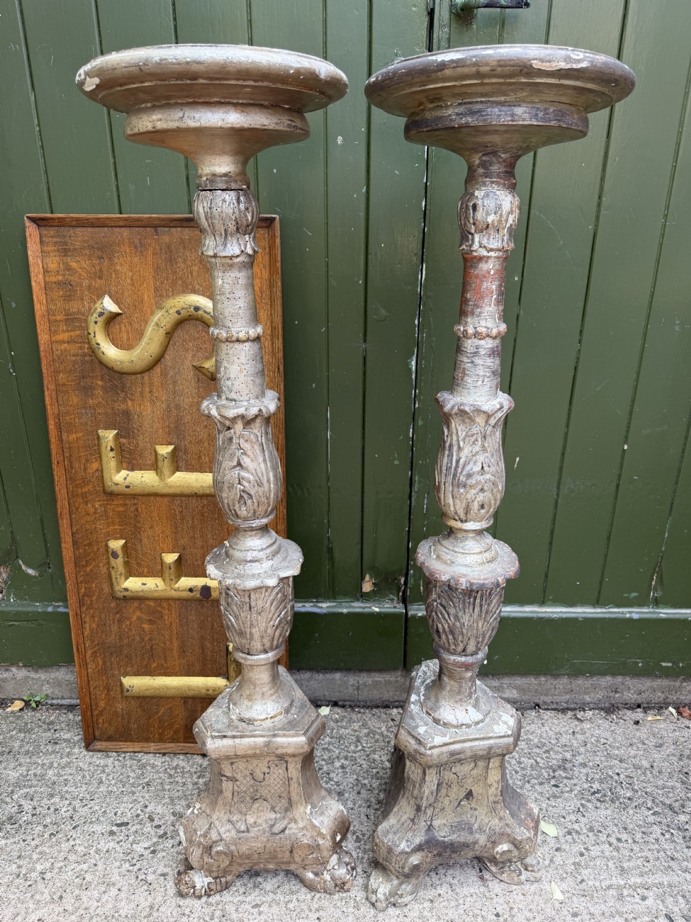 A pair of tall 18th-century Italian carved wood torcheres featuring baluster turned shafts with acanthus leaf details and an aged silver leaf finish. View II