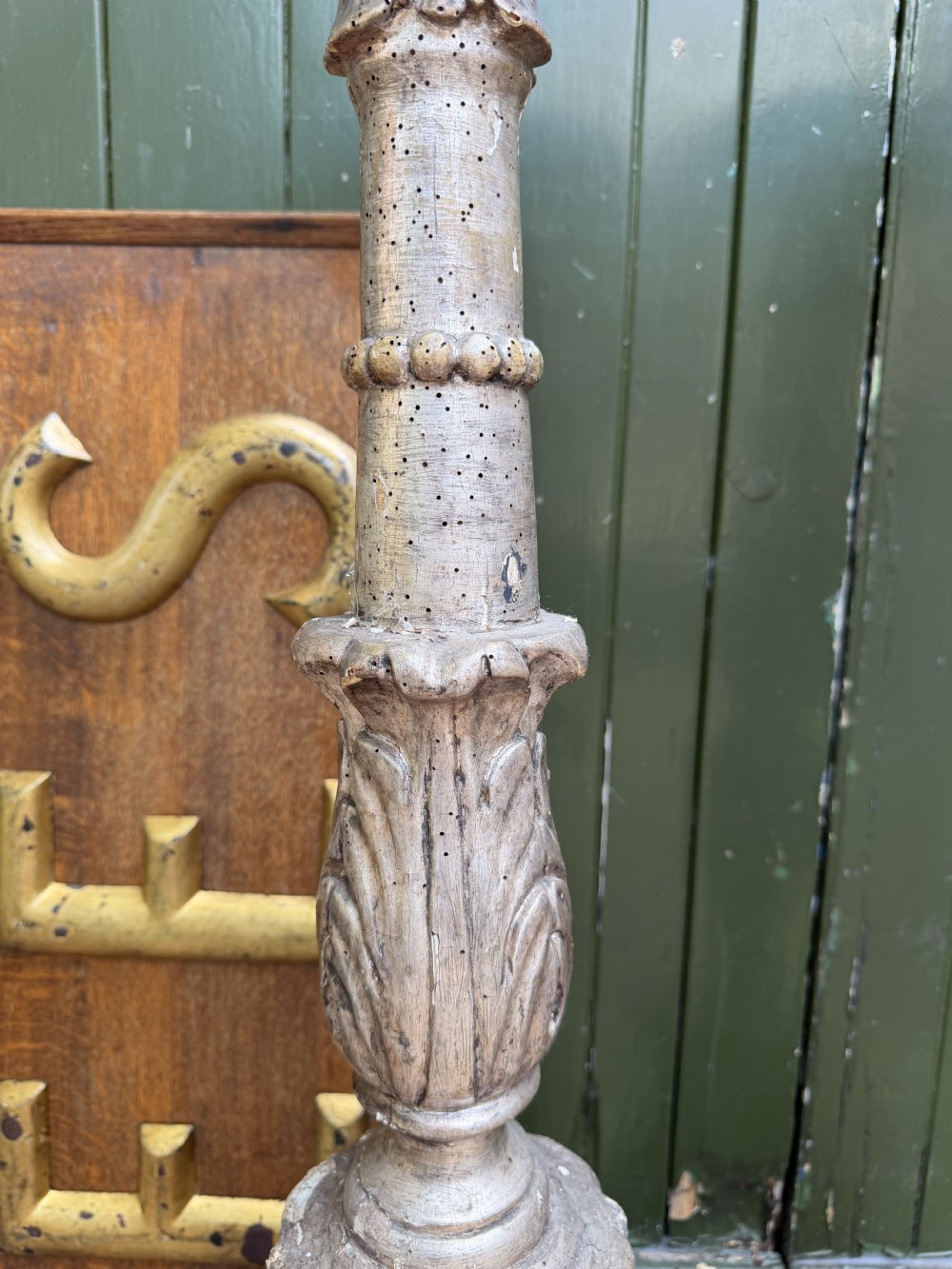 A pair of tall 18th-century Italian carved wood torcheres featuring baluster turned shafts with acanthus leaf details and an aged silver leaf finish. View VII