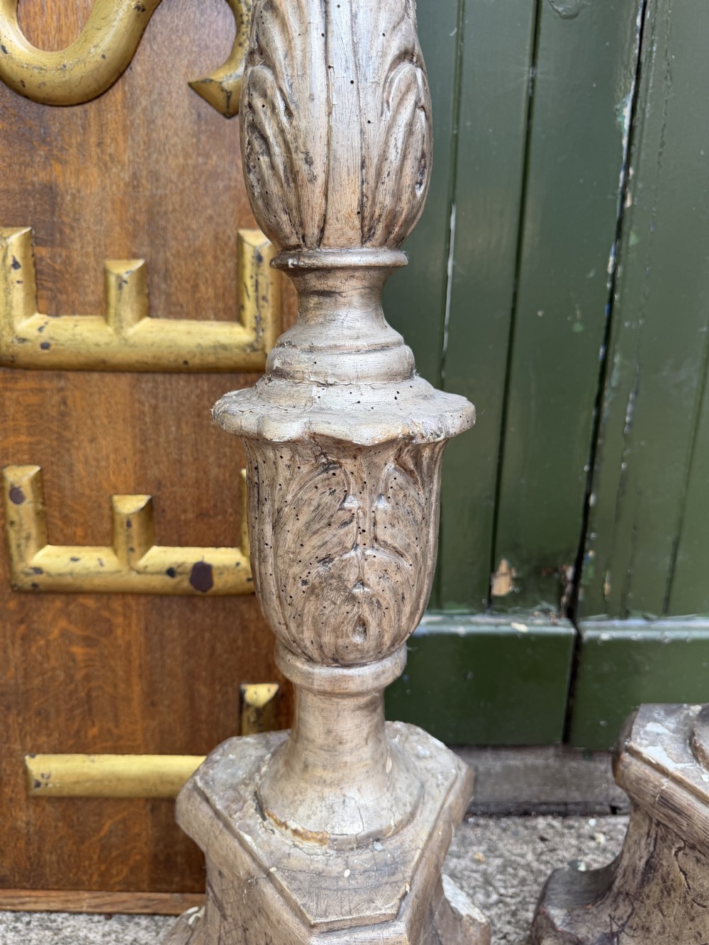 A pair of tall 18th-century Italian carved wood torcheres featuring baluster turned shafts with acanthus leaf details and an aged silver leaf finish. View VIII