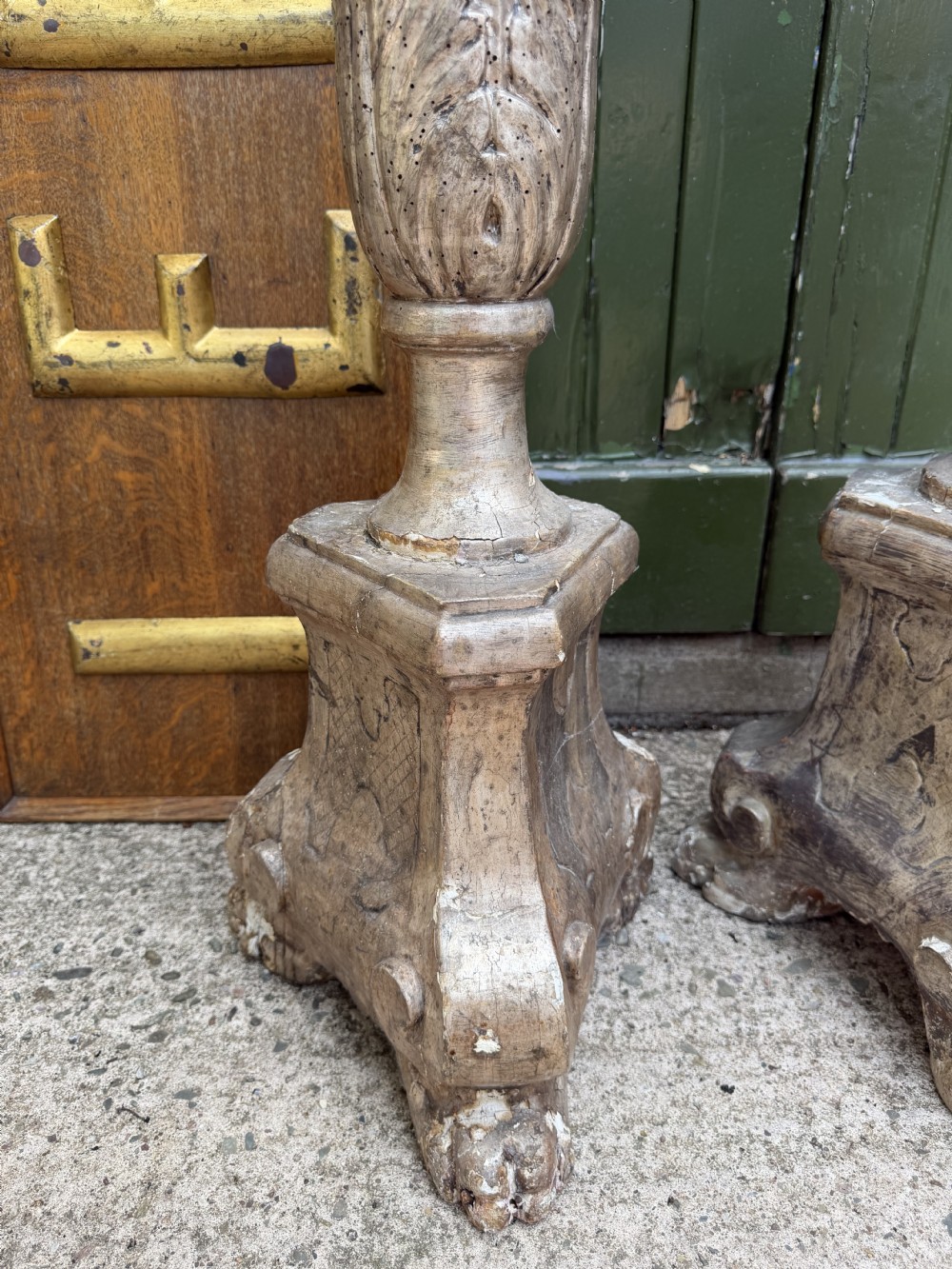A pair of tall 18th-century Italian carved wood torcheres featuring baluster turned shafts with acanthus leaf details and an aged silver leaf finish. View IX