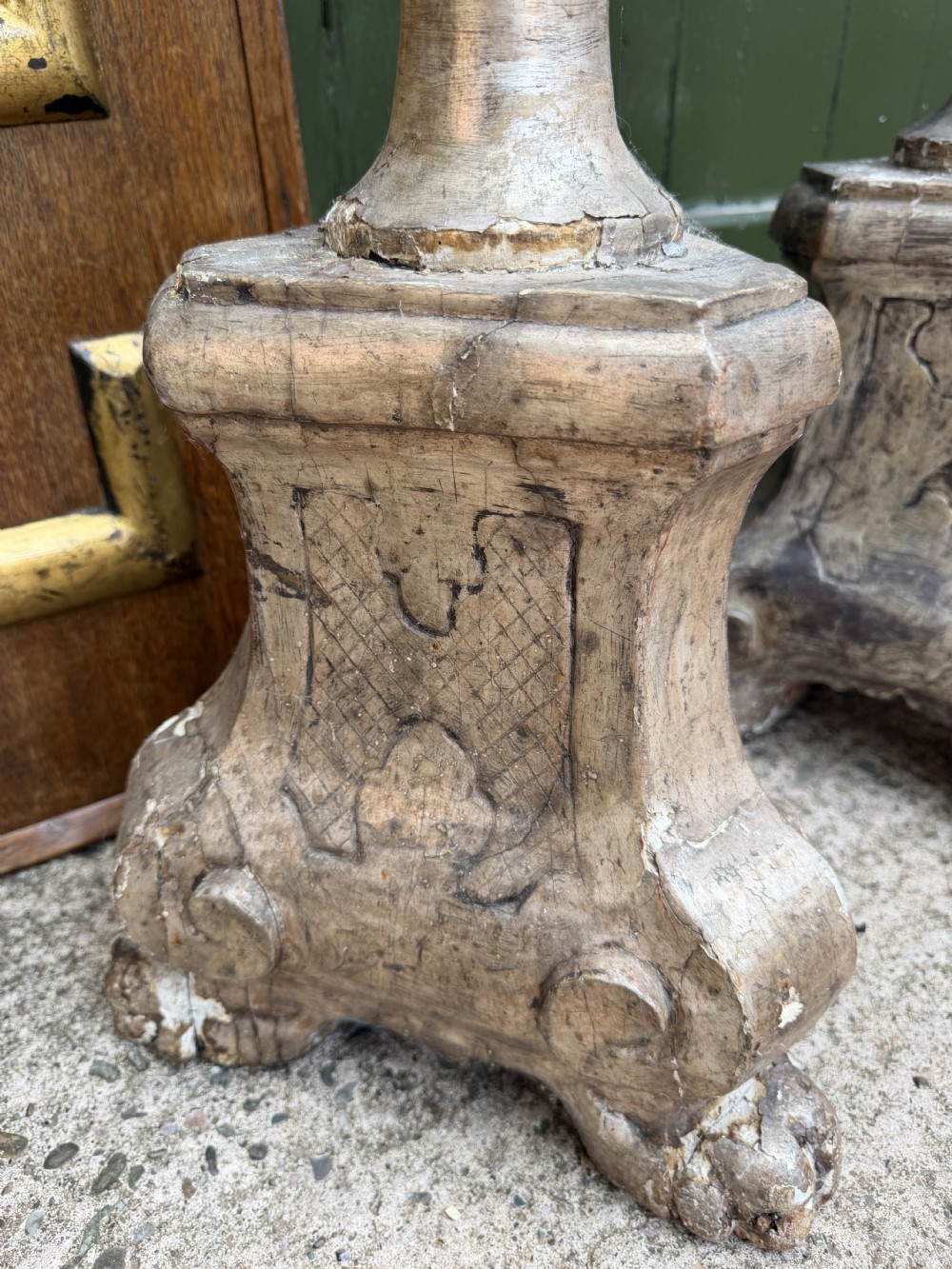 A pair of tall 18th-century Italian carved wood torcheres featuring baluster turned shafts with acanthus leaf details and an aged silver leaf finish. View X