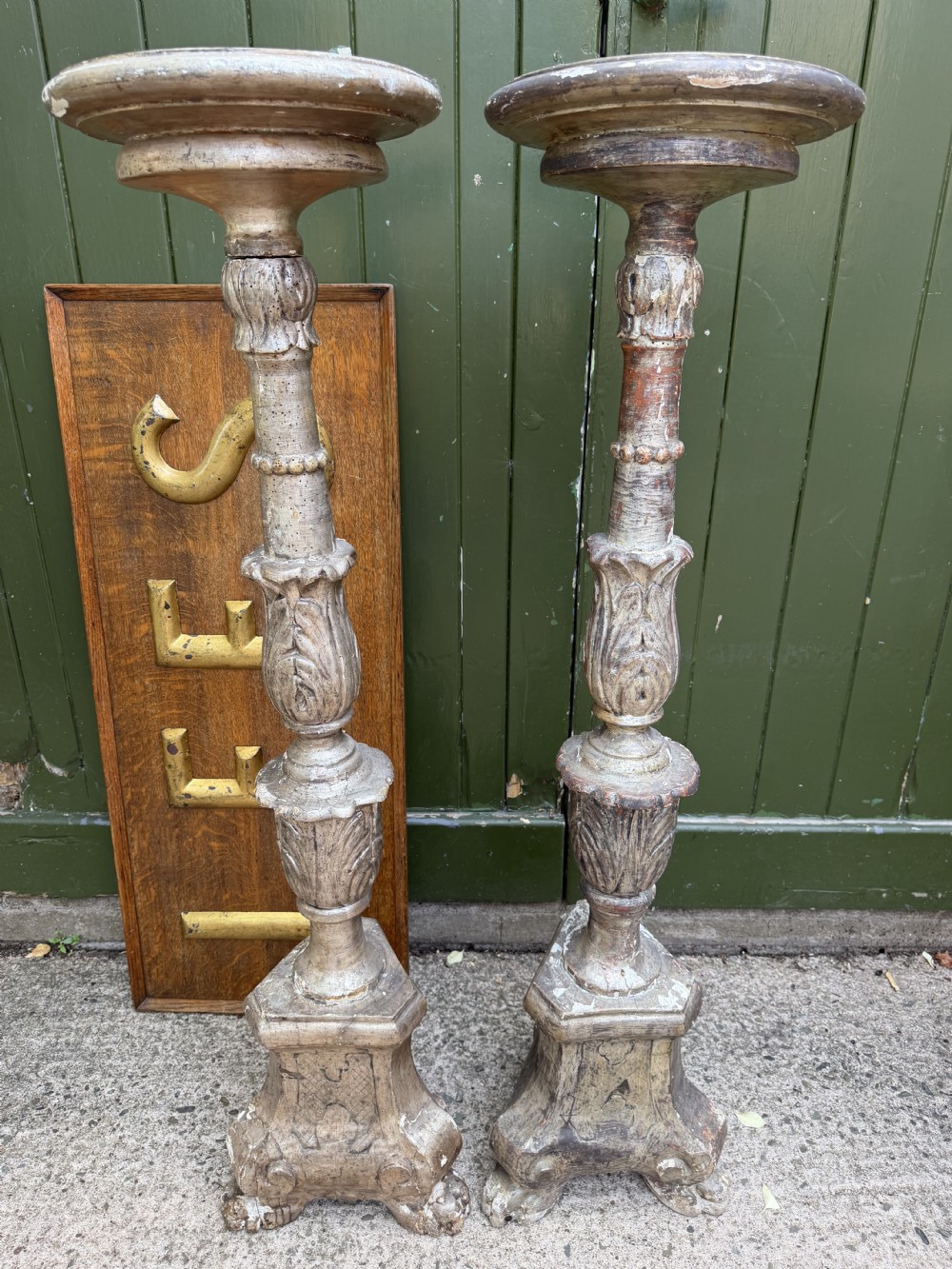 A pair of tall 18th-century Italian carved wood torcheres featuring baluster turned shafts with acanthus leaf details and an aged silver leaf finish. View XVII