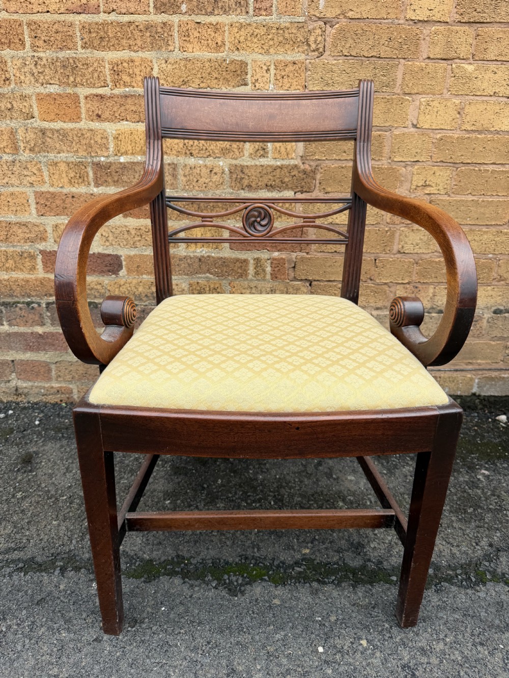 A set of eight late eighteenth-century George III mahogany dining chairs, comprising six side chairs and two armchairs with carved back rails and patterned yellow upholstered seats. View VI
