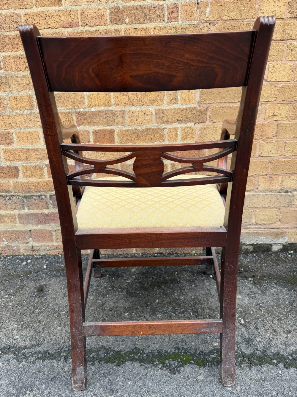 A set of eight late eighteenth-century George III mahogany dining chairs, comprising six side chairs and two armchairs with carved back rails and patterned yellow upholstered seats. View XI