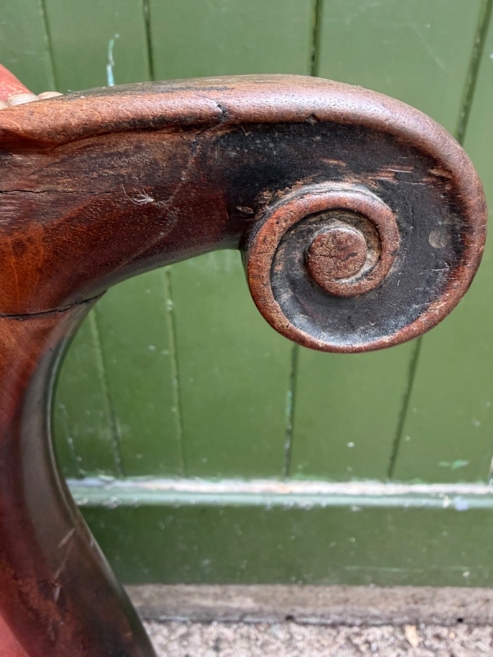 An 18th-century George III Gainsborough library armchair upholstered in aged red leather with a mahogany frame, padded armrests, brass stud trim, and brass castors. View IV
