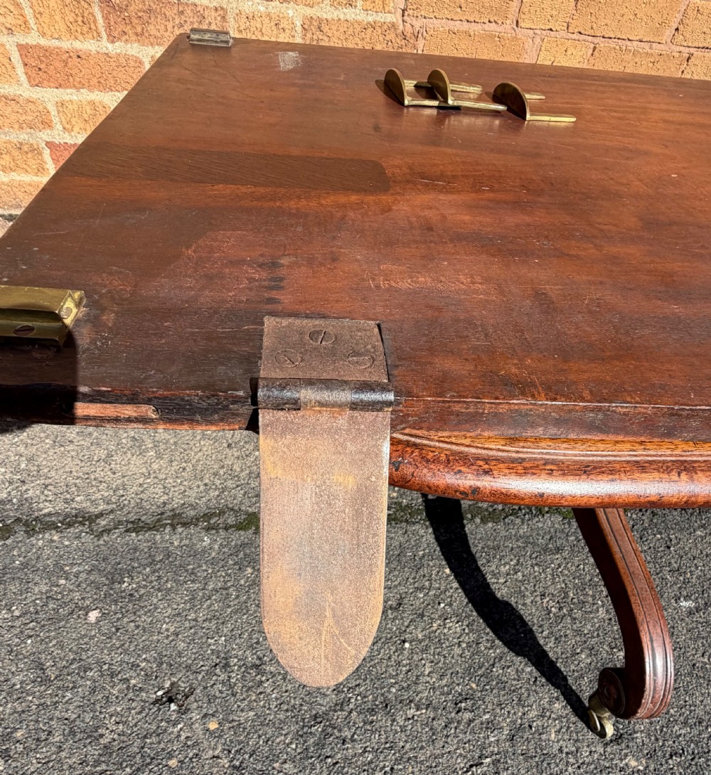 An early 19th-century George III twin-pillar mahogany dining table featuring reeded splayed legs and original brass castors. View XVII
