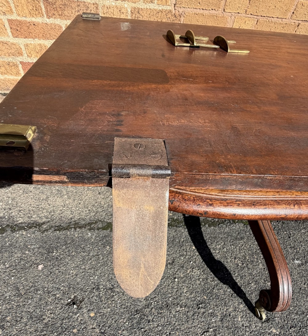 An early 19th-century George III twin-pillar mahogany dining table featuring reeded splayed legs and original brass castors. View XXVI