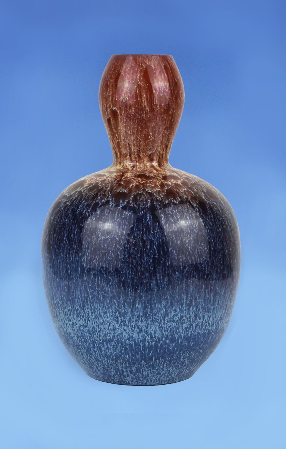 A bulbous earthenware vase featuring a mottled dark blue lower body transitioning into a textured brown dripping glaze along the narrow neck.