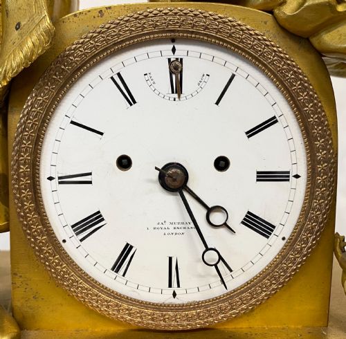 fig 2. A nineteenth-century gilt bronze figural mantel clock depicting a seated artist and companion figure above a white enamel dial with Roman numerals.