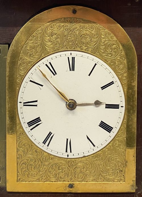 fig 2. A miniature architectural mahogany mantel clock with corner spires, a domed roof, and an engraved brass dial with Roman numerals.