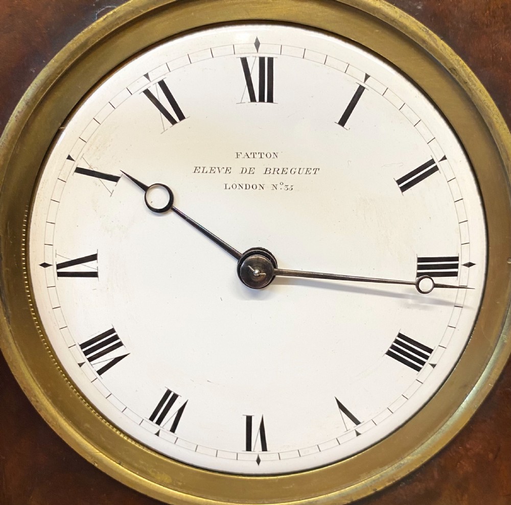 An early 19th-century Empire period Cuban mahogany mantel clock featuring an architectural case supported by four columns around a circular white enamel dial. View III