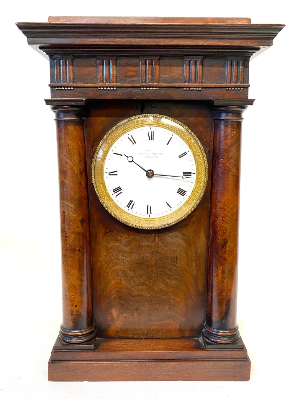 An early 19th-century Empire period Cuban mahogany mantel clock featuring an architectural case supported by four columns around a circular white enamel dial. View VII