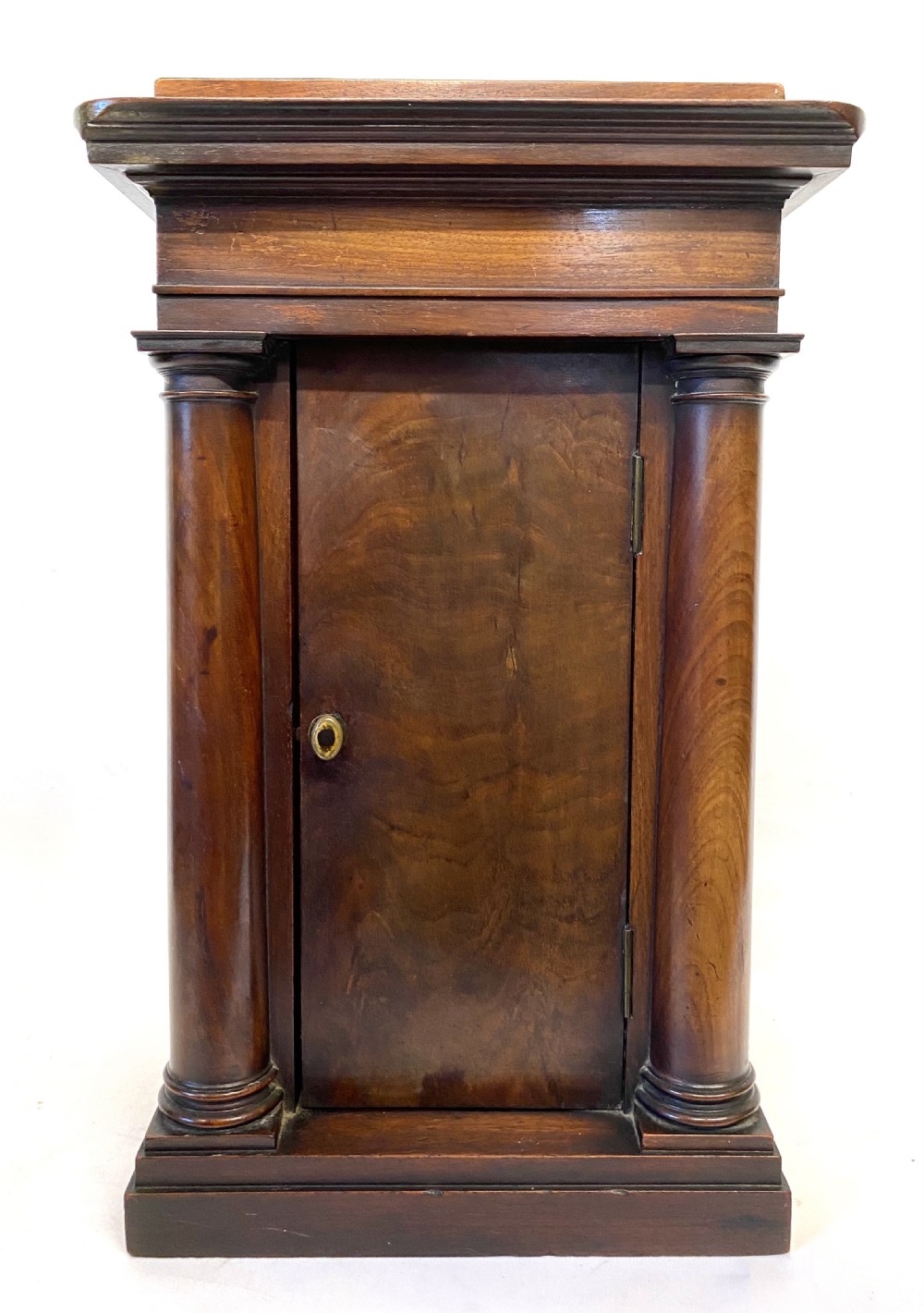 An early 19th-century Empire period Cuban mahogany mantel clock featuring an architectural case supported by four columns around a circular white enamel dial. View XVII